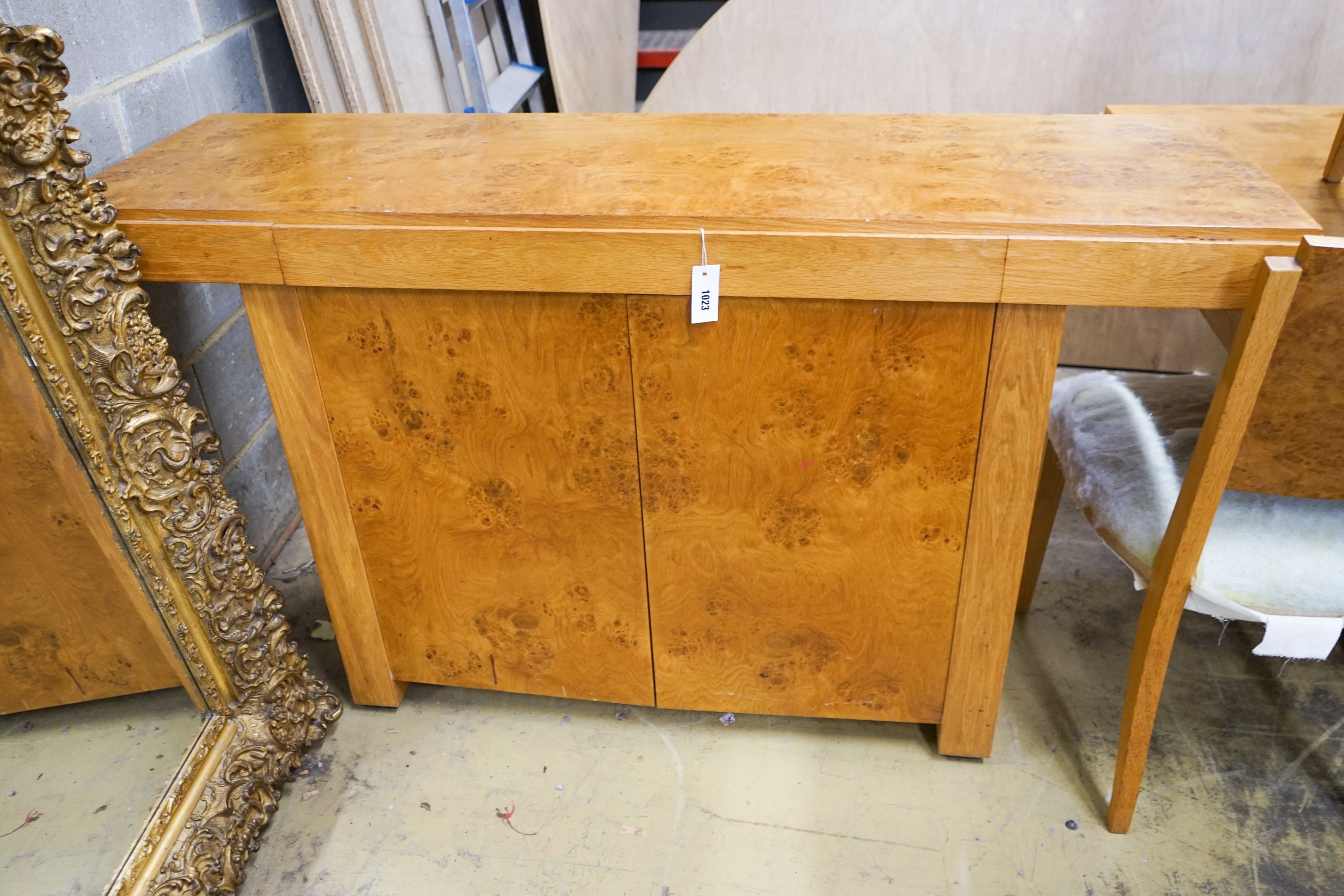 An Art Deco style bird's eye maple dining suite comprising table, six chairs and side cabinet, table length 200cm, width 104cm, height 72cm